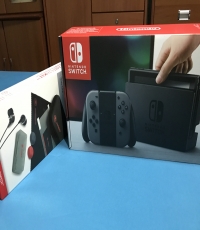 Nintendo switch with bomberman game and other accessories.
